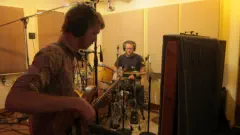 Bassist and Drummer laying down music in Mirror Sound's Drum Room