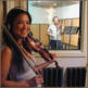 Violin player smiling for a photo in Mirror Sound's Isolation Booth