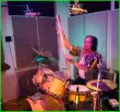 Robert Hammerstrom using a rainstick in the drum room.